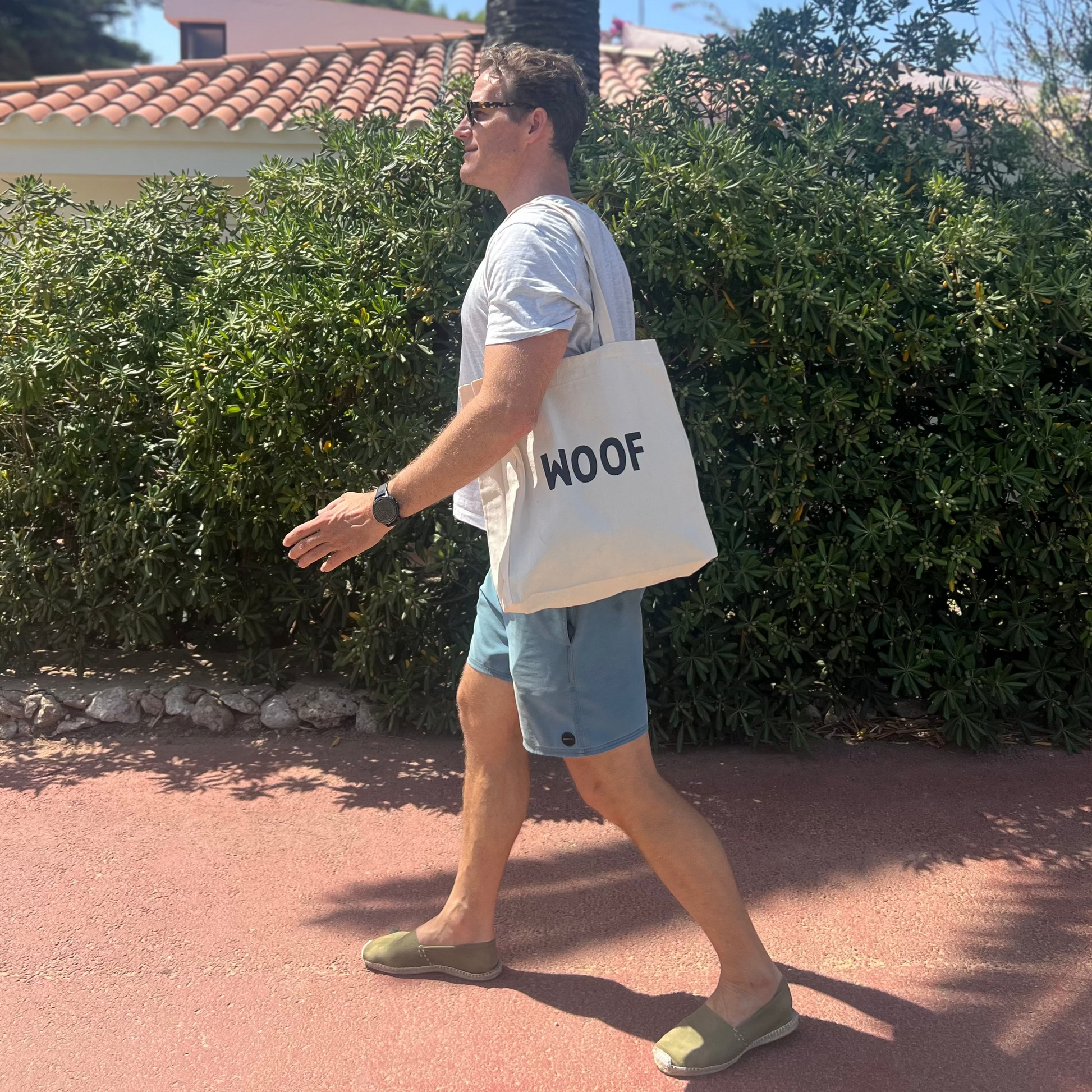 Man walking with a WOOF tote bag