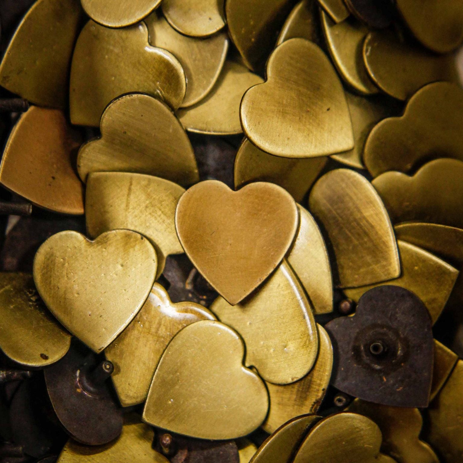 brass heart studs for dog collars in our workshop, Creature Clothes