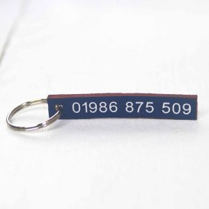 Personalised indigo leather key fob embossed phone number silver